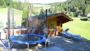 A wooden cabin with a trampoline, outdoor seating, and a hot tub. - Freiburg, Southern Black Forest, Schauinsland Hofsgrund, farm houses, (Oberried)