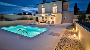 Una piscina al aire libre, una piscina climatizada