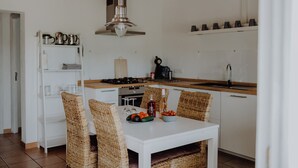 A compact kitchen with white cabinets, a wooden countertop, and a hanging light fixture. - Small but nice finca with great views and pool near Cala Ratjada (Capdepera)