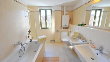 Combined shower/tub, hair dryer, towels, soap
