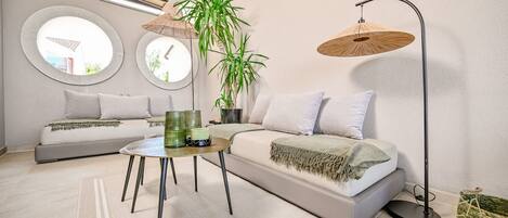 A modern living room with a sofa, a coffee table, and a floor lamp.