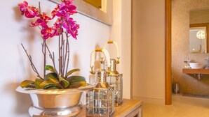 A bathroom vanity with a mirror, a sink, and a decorative plant. - Seafront Villa Prova 2***** with a top view, indoor & outdoor pool on Krk (Malinska)