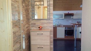 A modern kitchen with a built-in oven, a microwave, and a sink.