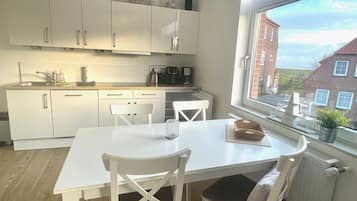 Fridge, stovetop, dishwasher, coffee/tea maker