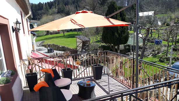 A balcony with outdoor furniture, a grill, and a view of a green landscape. - Take a few days blue, in the holiday home Blue (Berlingen)