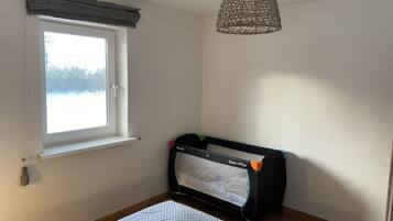 Cozy retreat with a single bed, window, and pendant light.