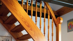 A wooden staircase with a horse figurine at the bottom.