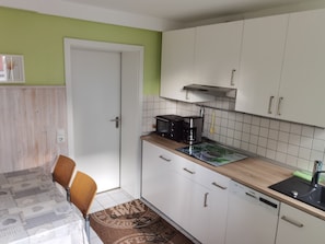 A compact kitchen with white cabinets, a microwave, a coffee maker, and a dishwasher. - Holidays in Oberhof -. Thuringia ski No. 1 next to the Rennsteig (Oberhof)