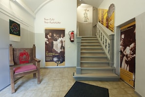 Staircase leads to an upper level with a simple design, featuring a handrail and steps.