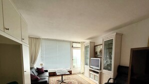 A living room with a sofa, TV, and cabinets. - Private residence (Timmendorfer Strand)