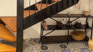 A staircase with black railings and wooden steps, leading to a lower level. - HOLIDAY HOUSE DIRECTLY BY THE SEA (Oliva Playa)
