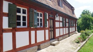 A traditional half-timbered building with a stone pathway leading to the entrance.