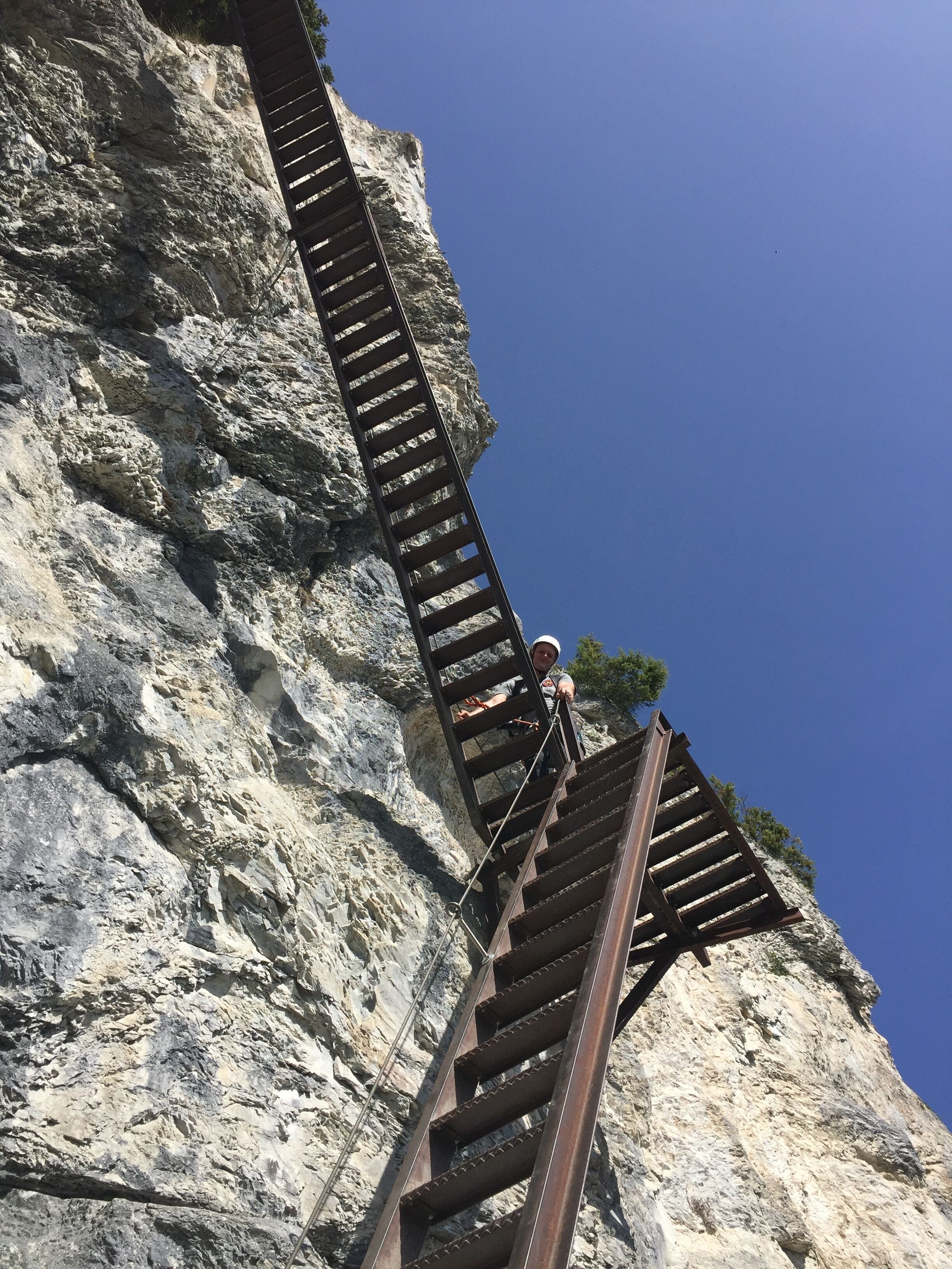 A metal staircase attached to a rocky cliff.
