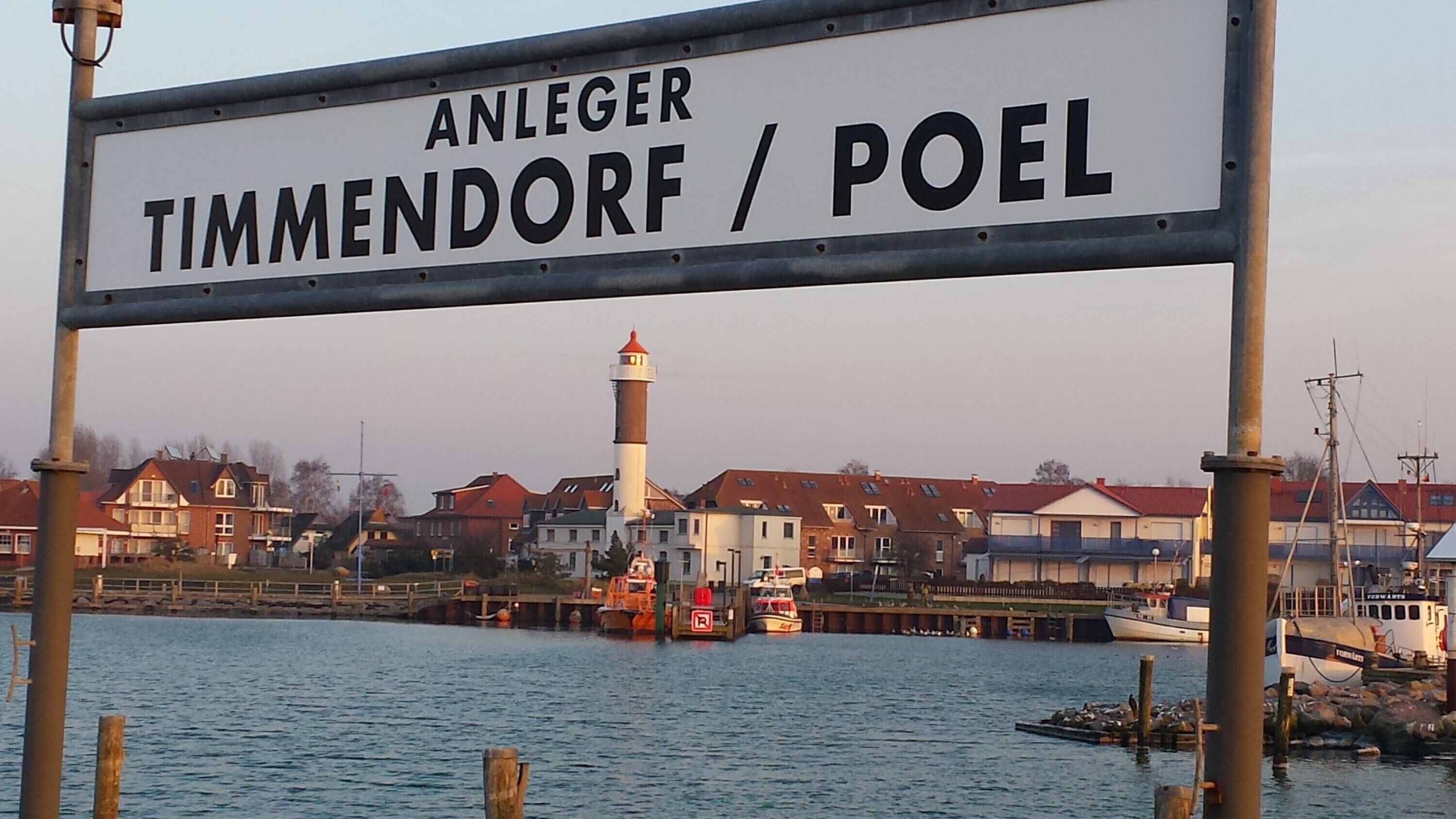 A sign with the text 'ANLEGER TIMMENDORF / POEL' indicating a location.