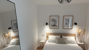 A modern bedroom with a large bed, bedside tables, a mirror, and framed artwork on the wall. - Villa Antonija, 50 m from sandy beach, heated pool, max 12 pax (Omis)