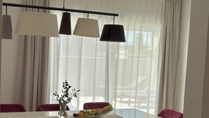 A dining area with a white table, purple chairs, a fruit bowl, and a vase with a plant. - Villa Antonija, 50 m from sandy beach, heated pool, max 12 pax (Omis)
