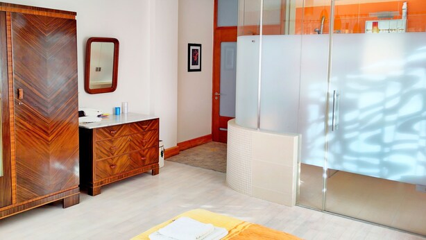A modern bathroom with a wooden vanity, a mirror, and a glass shower enclosure. - 125m² Hohberg near Black Forest, Strasbourg, Europapark, Offenburg, Baden-Baden (Hohberg)