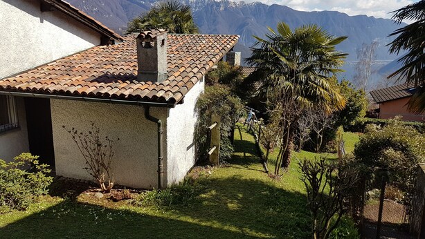 A house with a tiled roof, surrounded by greenery and a mountain backdrop. - Nice Mediterranean holiday home. Ideal for families, athletes etc. Nature lovers (Carona)