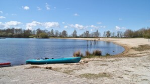 Un lago tranquillo con un pontile e una canoa.