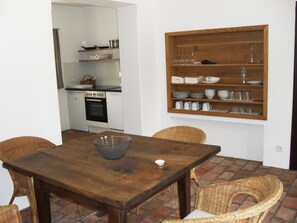 Enjoy meals in a functional kitchen and dining area with a wooden table and modern appliances.