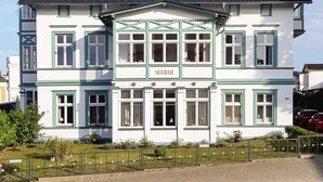 A two-story building with a sign reading "SEEBAR" on the front.