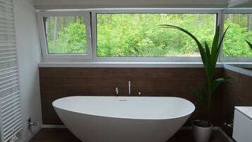 Bathtub, hair dryer, towels, toilet paper