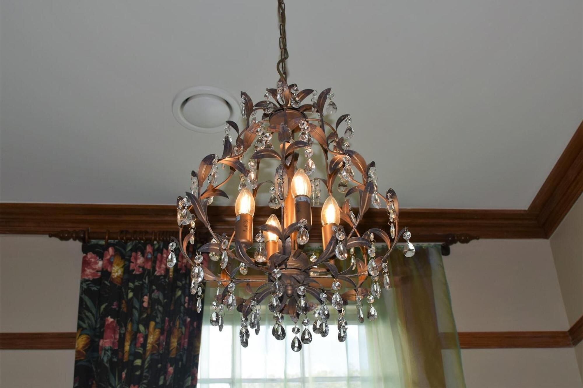 A chandelier with multiple lights and crystal decorations.