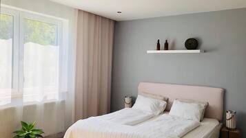 Tabla de planchar con plancha y ropa de cama