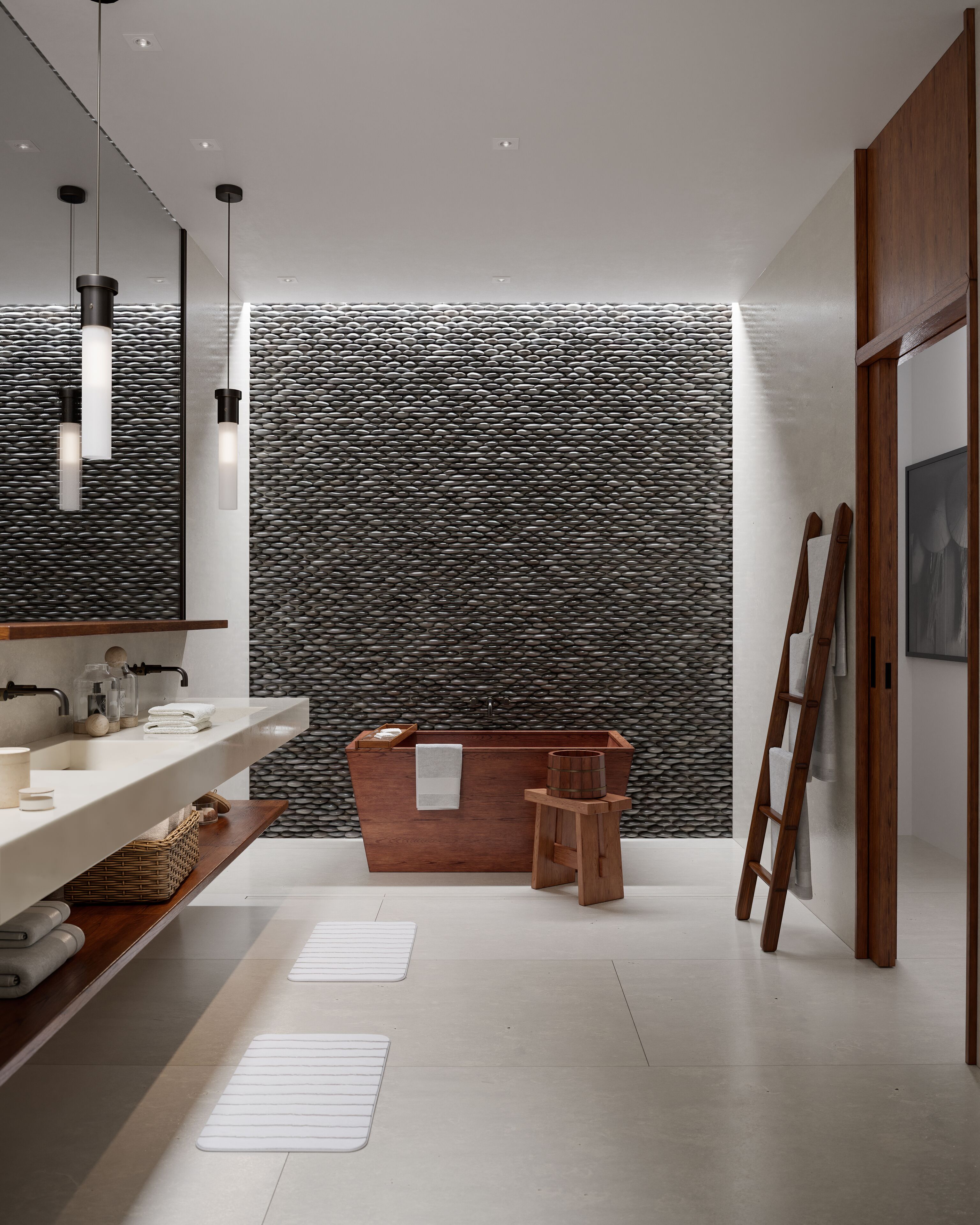 A modern bathroom with a large mirror, two pendant lights, a wooden vanity, a bathtub, and a textured wall.
