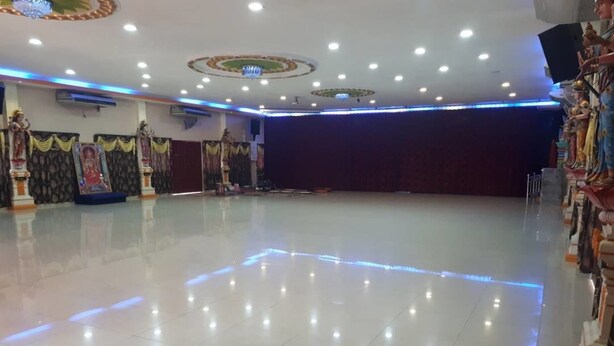 A spacious hall with a polished floor, ceiling lights, and decorative statues. - Persatuan Kebajikan Sri Sakthi Ashram - Hostel (Tangkak)