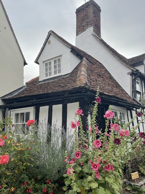 A traditional Tudor-style house with a steeply pitched roof, white exterior walls, and dark timber framing. - 15th Century Period Cottage In Saffron Walden, Essex England (Saffron Walden)