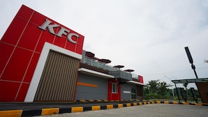 A KFC restaurant with a prominent red and white facade, a covered outdoor seating area, and a paved entrance. - My Studio Hotels Kualanamu Airport Medan (Medan)