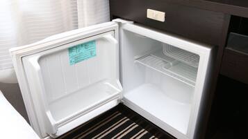 An open refrigerator with a control panel and a note on the door.