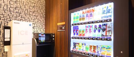 A vending machine with a screen displaying various drink options.