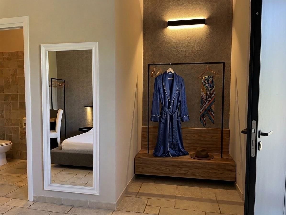 A hotel room with a wooden bench, a robe, and a hat on the bench.