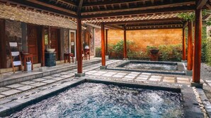 A traditional Japanese-style spa with stone hot tubs and wooden structures. - Pilgrimage Wellness Retreat – part of Pilgrimage Village Resort & Spa (Hue)