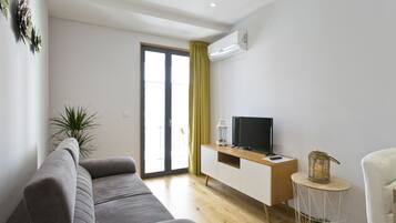Apartment Superior 4 with Balcony | Living area | 80-cm flat-screen TV with satellite channels, TV