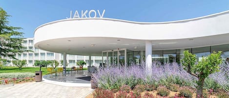 A modern building with the name "JAKOV" prominently displayed.