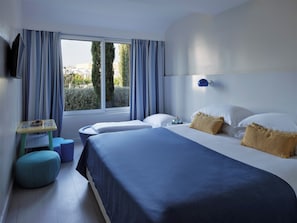 A hotel room with two beds, a small table, and a window with curtains. - Amadria Park Kids Hotel Andrija (Sibenik)