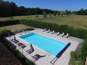 Seasonal outdoor pool, open 9:30 AM to 8:00 PM, pool umbrellas