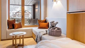 Enjoy a peaceful retreat with a comfortable bed, cozy seating area, and stunning views of the snowy landscape.