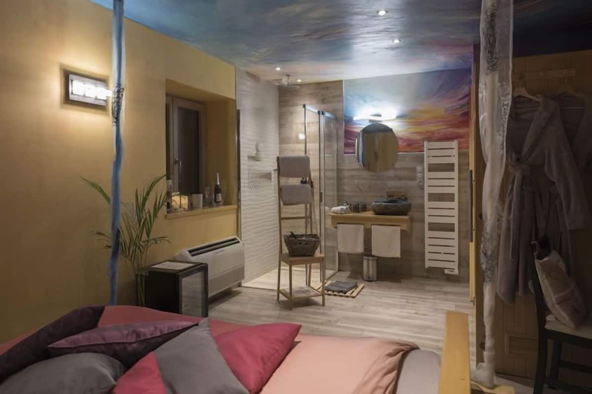 A modern bathroom with a shower, a vanity, and a towel rack.