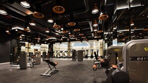 A gym with various exercise machines, mirrors, and overhead lighting. - Ottoman's Life Hotel Deluxe (Istanbul)