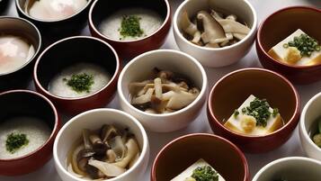 A variety of bowls containing different types of food, likely a selection of Japanese dishes.