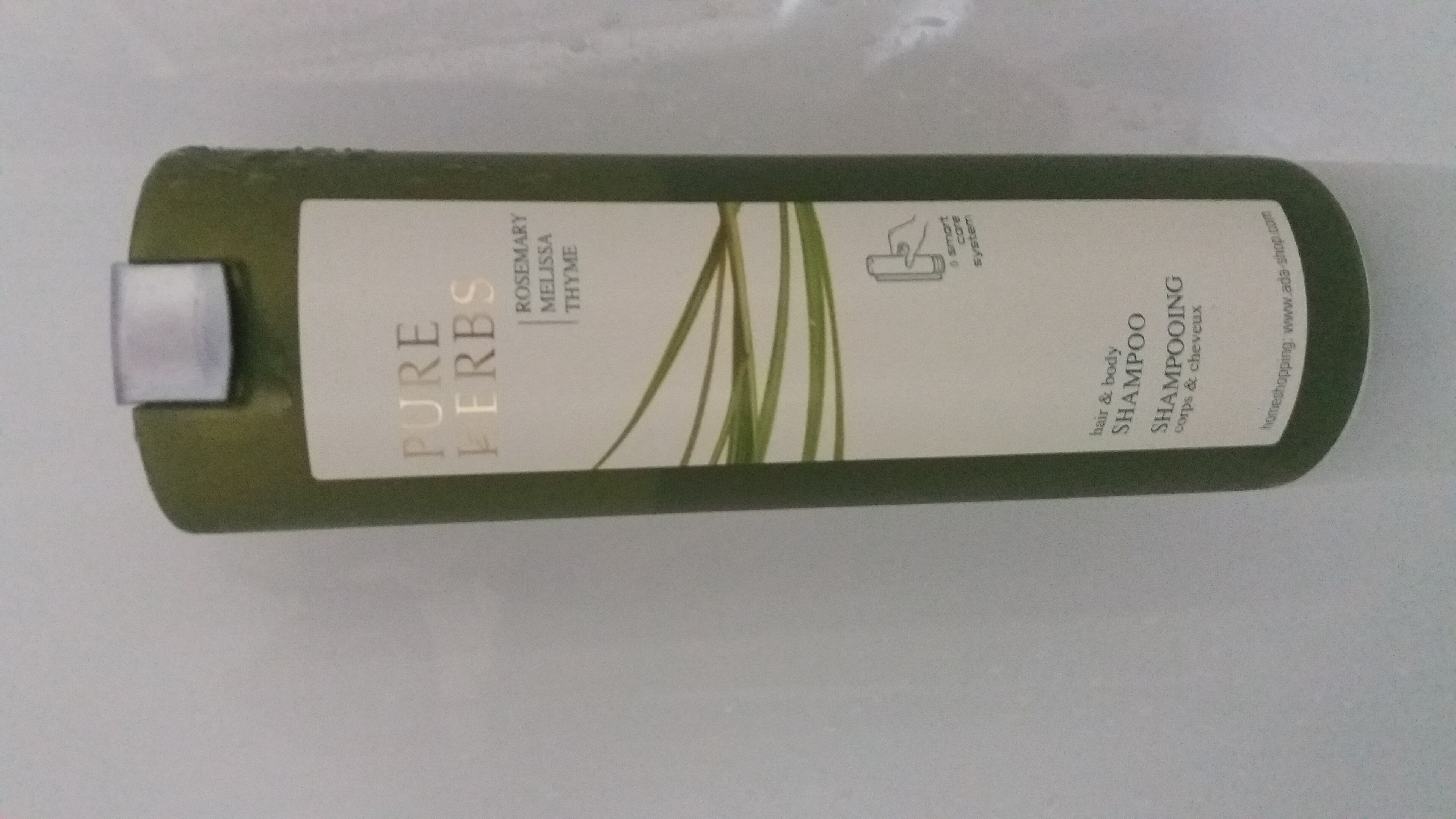 A bottle of Pure Herbs Rosemary & Melissa Thyme shampoo.