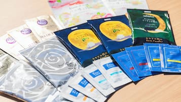 A variety of packaged products, including hair care items and bath powders, arranged on a wooden surface.
