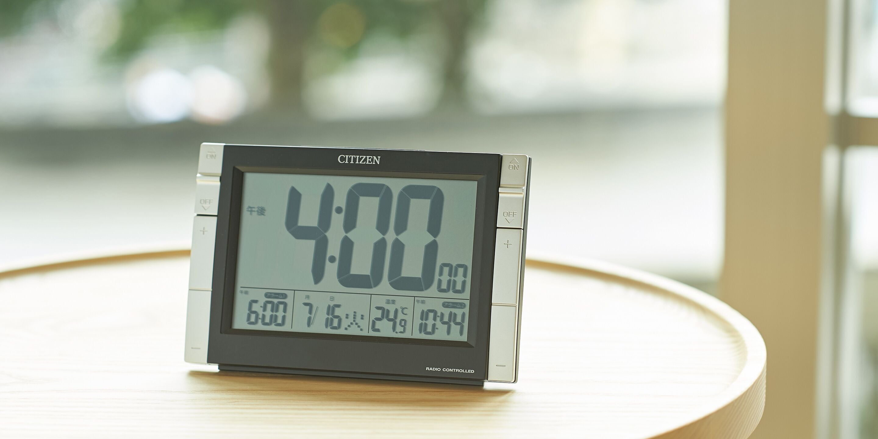 A digital clock displaying 4:00 on a table.