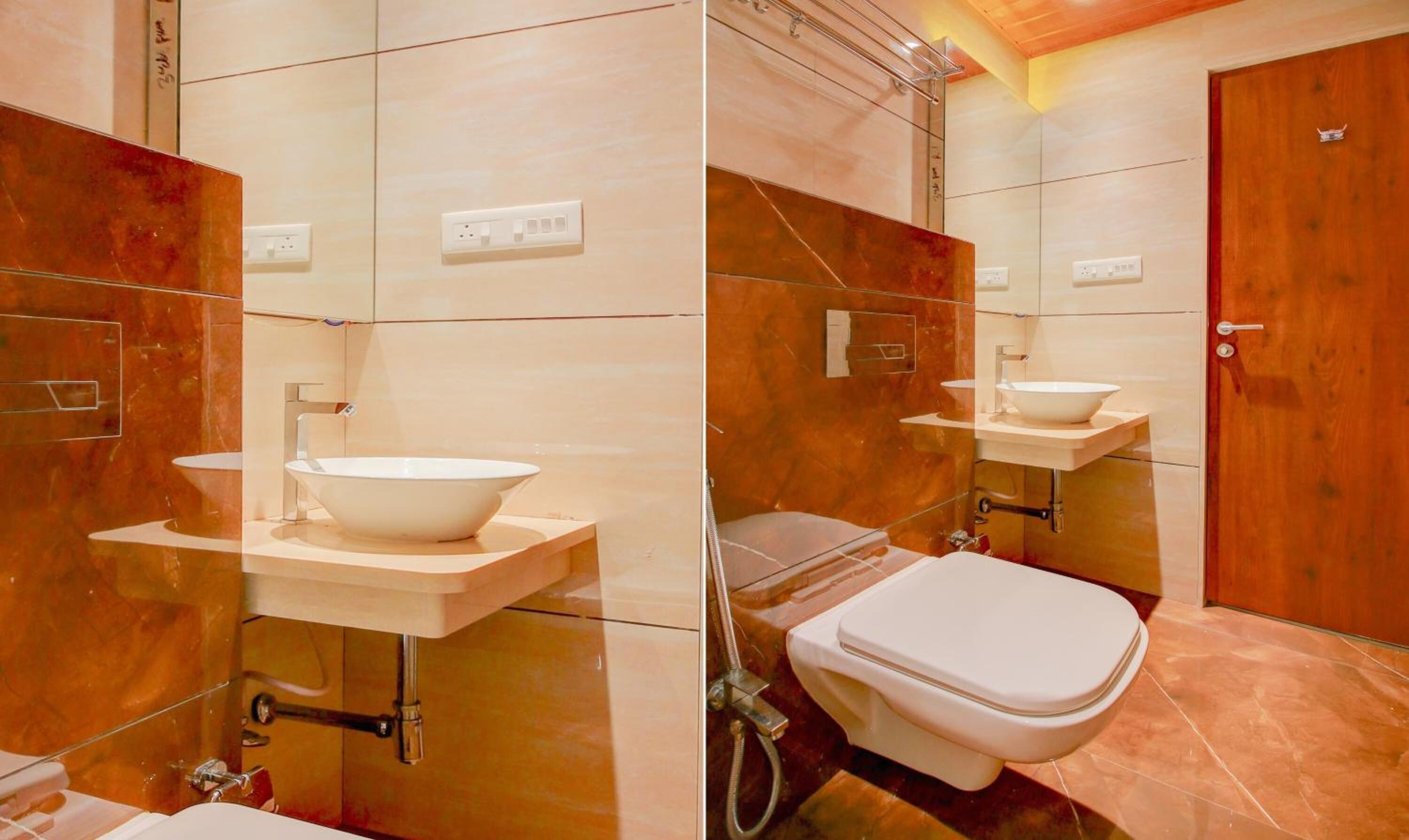 Un baño moderno con un lavamanos blanco grande, inodoro y ducha.