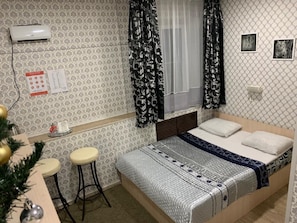 Enjoy a restful stay in this cozy space with a single bed, table, and chair.