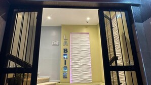 A hotel entrance with a prominent "HOTEL" sign above the doors. - Hôtel La Brise (Ain El Turk)